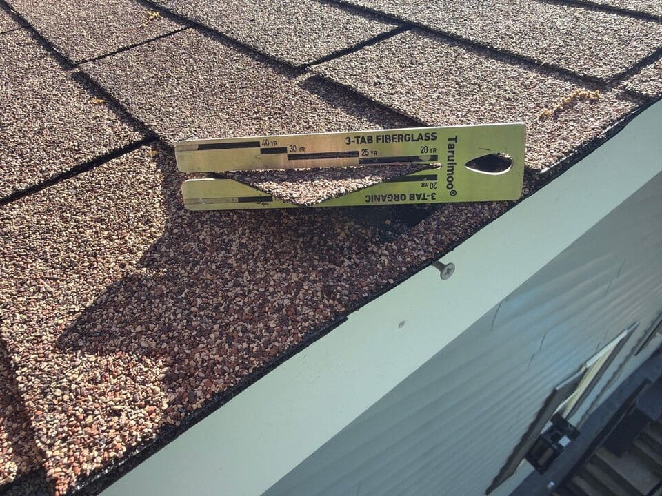 Residential roof inspection checking for storm damage
