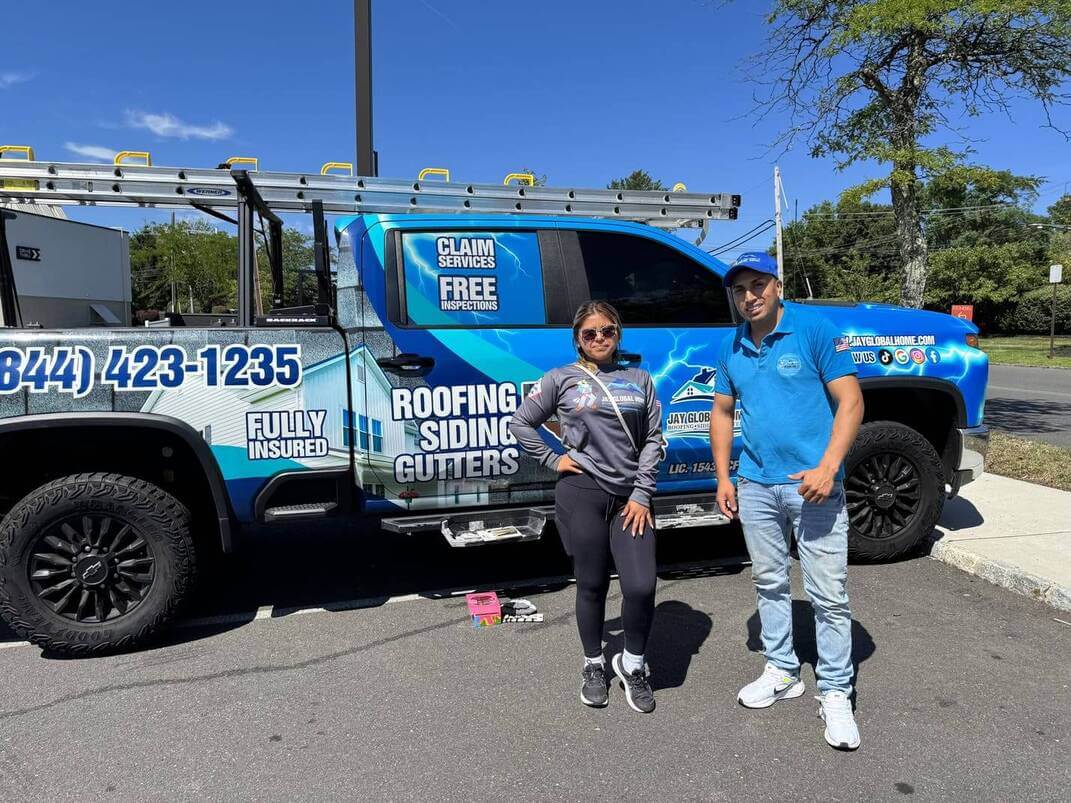 Jay Global Home roofers standing next to their service truck