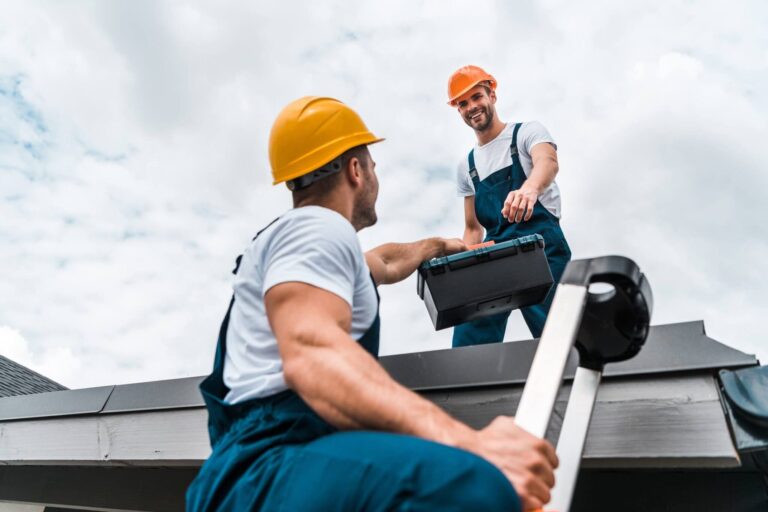 Roofers preparing tools before a roof repair job